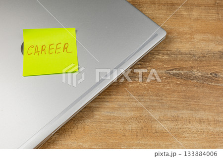 Sticky note with career reminder on laptop at home office desk 133884006