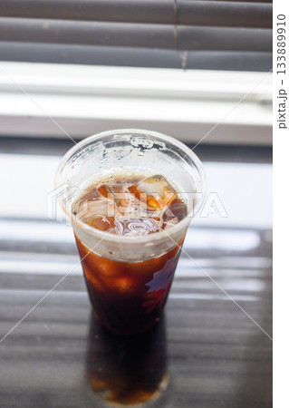 Iced black coffee in a plastic cup 133889910