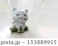 A damaged and dirty cat plaster sculpture. 133889915
