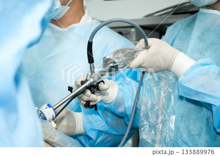 The surgeon operates with laparoscopic manipulators. The surgeon operates with laparoscopic manipulators. 133889976