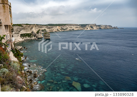 Aerial view marina cape Bonifacio south Corsica France citadel on rocky promontory on wild white limestone cliffs 133890328