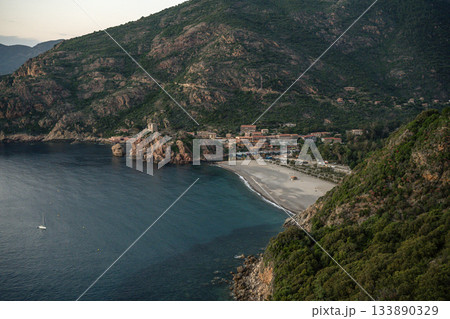 Aerial view town ruins Genoese tower of Porto Corsica France medieval watchtower Mediterranean Sea Calanches de Piana 133890329