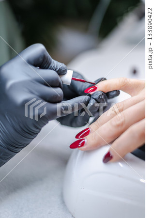 Detailed view of professional manicure procedure with nail care tools and hands in focus. 133890422