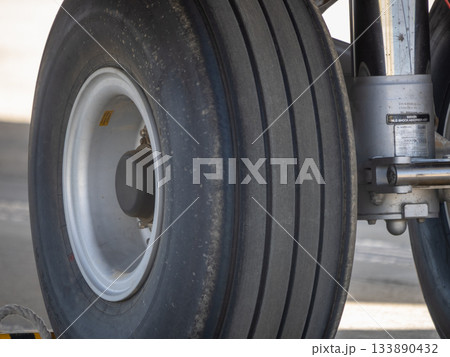 Close-up of aircraft nose landing gear wheel assembly 133890432