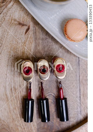 Detailed view of professional manicure procedure with nail care tools and hands in focus. Detailed view of professional manicure procedure with nail care tools and hands in focus. 133890453