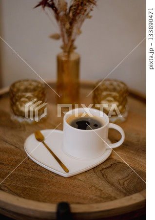 Warm cup of coffee served to a client in a beauty nails salon, creating a cozy and relaxing atmosphere. 133890471
