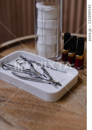 Detailed view of professional manicure procedure with nail care tools and hands in focus. 133890542
