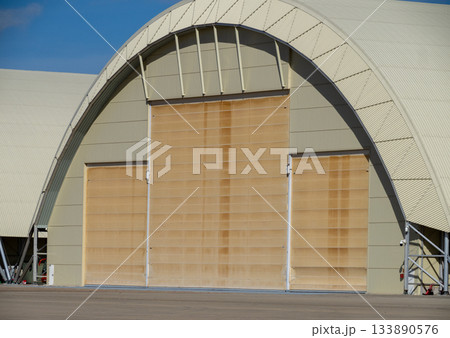 Aircraft hangar with large sliding door at air base 133890576