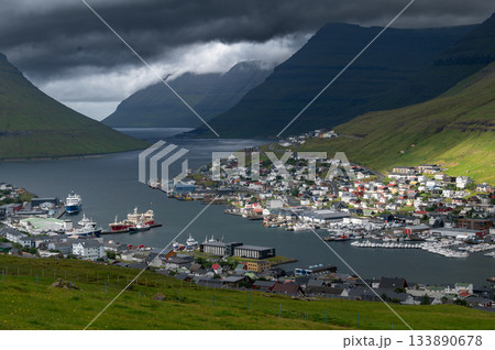 Breathtaking panoramic view of Klaksvik city, nestled among fjords and mountains in the Faroe Islands, Denmark, North Atlantic. Breathtaking panoramic view of Klaksvik city, nestled among fjords and mountains in the Faroe Islands, Denmark, North Atlantic. 133890678