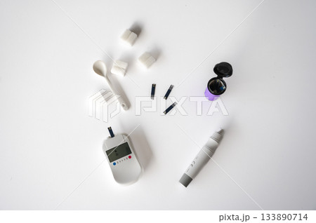 Close-up of a man's hands using a lancet on his finger to test blood glucose level. Concept of diabetes care, glycemia monitoring, and health management. Close-up of a man's hands using a lancet on his finger to test blood glucose level. Concept of diabetes care, glycemia monitoring, and health management. 133890714