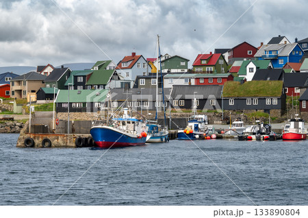 Scenic view of Nolsoy, Faroe Islands, with colorful fishermens houses by the sea, reflecting traditional Nordic charm and coastal lifestyle. Scenic view of Nolsoy, Faroe Islands, with colorful fishermens houses by the sea, reflecting traditional Nordic charm and coastal lifestyle. 133890804