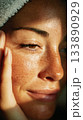 Woman's close up face with natural freckles and towel 133890929