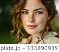 Young woman with red hair and freckles expressing natural beauty 133890935