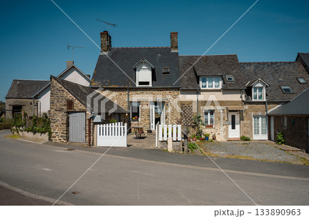 Charming street in quaint Menerbes village with colorful buildings and vibrant flowers. High quality photo 133890963