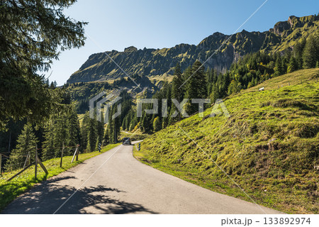 Car drives on Pragelpass road in the Swiss Alps, Muotathal, Canton of Schwyz, Switzerland 133892974