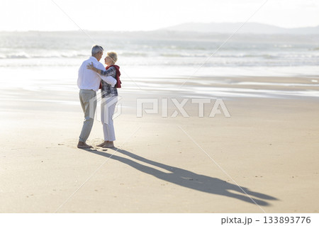 Senior couple enjoying romantic dance on beach Senior couple enjoying romantic dance on beach 133893776