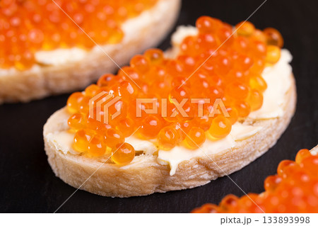 Sandwiches with red caviar. 133893998
