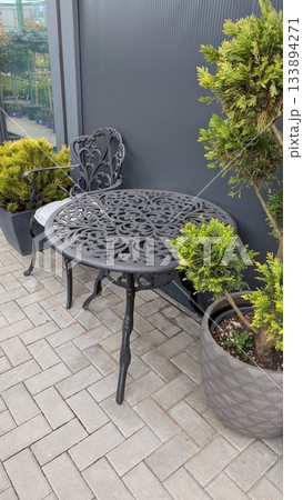 sunlit urban patio with seating, perfect spot for relaxing coffee or reading in tranquil city environment 133894271