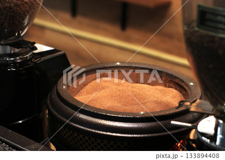 Freshly ground coffee fills a grinder bowl, ready for brewing. The fine, rich brown coffee powder offers an inviting aroma and promises a flavorful cup. Freshly ground coffee fills a grinder bowl, ready for brewing. The fine, rich brown coffee powder offers an inviting aroma and promises a flavorful cup. 133894408