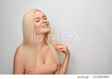 Beautiful Happy Woman with Blond Hair. Keratin Treatment, Lamination, Hair Botox and Brazilian Blowout. 133894964