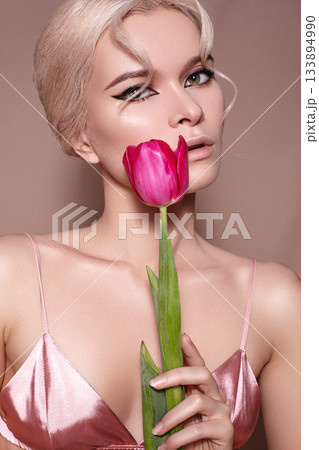 Beautiful sexy Blonde Woman with luxury Make-up. Girl with Spring Flowers Bouquet. Style for Womans Day or Valentines 133894990