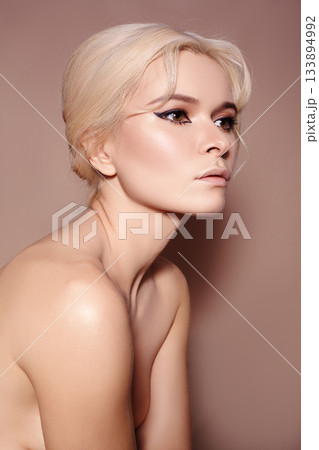 Sexy blond woman in retro style. Beautiful woman model in femininity pose with fashion make-up, soft skin, hairstyle Sexy blond woman in retro style. Beautiful woman model in femininity pose with fashion make-up, soft skin, hairstyle 133894992
