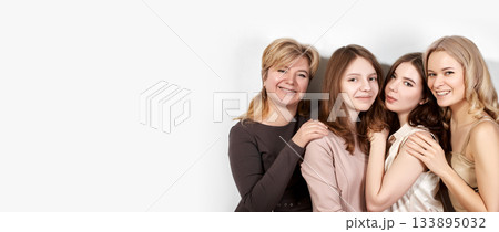 Happy Family of Mother with Three Daughters on Light Grey Background. Fashion Style Studio Portrait. 133895032