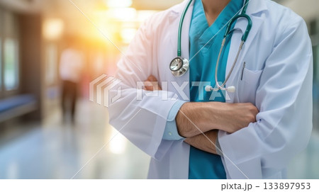 Health professional in a hospital corridor preparing for patient care during morning hours 133897953