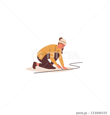 Woman drawing a curving line on paper while kneeling down demonstrates artistic focus and casual 133898335
