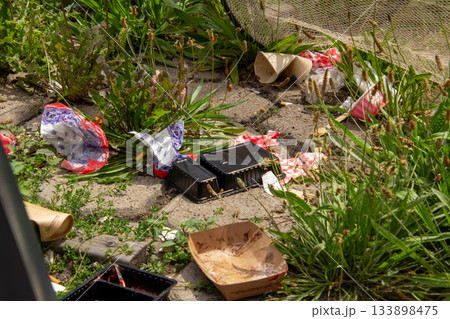 Catching garbage in a garbage bin or in a fishing net. Catching garbage in a garbage bin or in a fishing net. 133898475