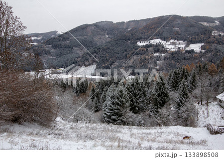 View over the valley with snow covered forest View over the valley with snow covered forest 133898508