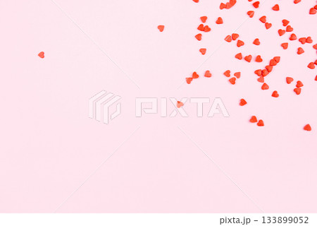 Tiny red hearts on pink background. Tiny red hearts on pink background. 133899052