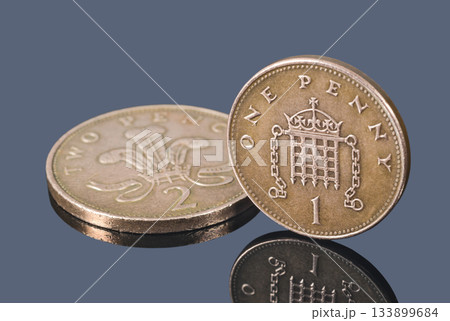 British copper coins isolated on a dark background 133899684