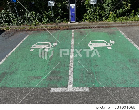 Parking lot with two electric car charging stations 133901069