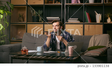 Man recording voice message at home workspace. 133901138