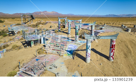 Aerial Abandoned Water Park Graffiti Structures in California Desert 133901239