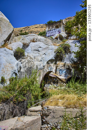 Abandoned Concrete Ruins and Graffiti Among Granite Rocks and Wild Vegetation Abandoned Concrete Ruins and Graffiti Among Granite Rocks and Wild Vegetation 133901295