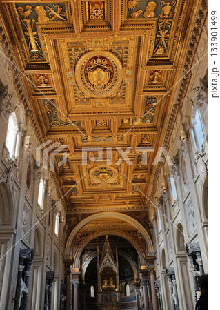 Archbasilica of Saint John Lateran Rome exterior facade and grand baroque interior with golden coffered ceiling vast nave marble statues side chapels ornate altar apse and dome Catholic basilica 133901499