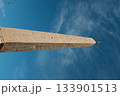 Lateran Obelisk in Piazza San Giovanni in Laterano Rome under blue sky ancient Egyptian granite monument with Latin base inscriptions city square landmark travel Italy. High quality photo 133901513