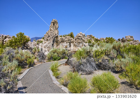 Tufa Formations and Walking Path with Native Brush Under Blue Sky 133901620