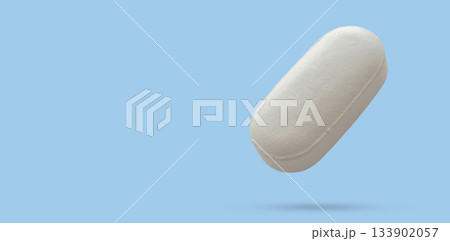 White medicine pill tablet float on blue background 133902057