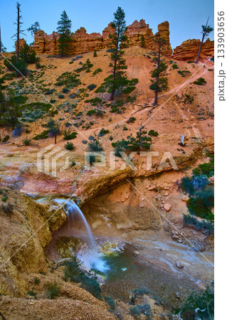 Mossy Cave Waterfall and Hoodoo Cliffs with Pine Trees in Bryce Canyon National Park 133903656