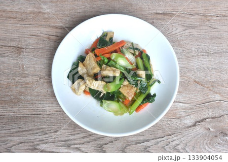 fried Kailaan Chinese kale and carrot with tofu dressing soy sauce vegetarian food on plate fried Kailaan Chinese kale and carrot with tofu dressing soy sauce vegetarian food on plate 133904054