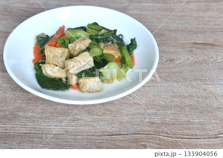 fried Kailaan Chinese kale and carrot with tofu dressing soy sauce vegetarian food on plate 133904056