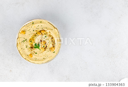 Lupin hummus in white bowl with parsley on white background. Vegan food. Top view. Copy space. 133904363