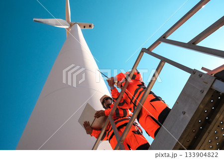 Engineers are inspecting wind turbines to generate electricity. Engineers are inspecting wind turbines to generate electricity. 133904822