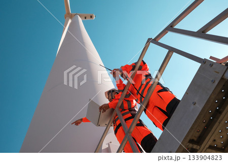 Engineers are inspecting wind turbines to generate electricity. Engineers are inspecting wind turbines to generate electricity. 133904823