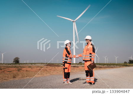 Engineers are inspecting wind turbines to generate electricity. 133904847
