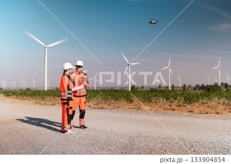 Engineers are inspecting wind turbines to generate electricity. Engineers are inspecting wind turbines to generate electricity. 133904854