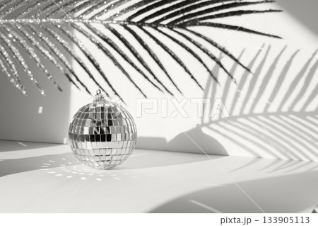 Disco ball in sunlight with geometric palm leaf shadow and reflections on background color of 2026 year cloud white Disco ball in sunlight with geometric palm leaf shadow and reflections on background color of 2026 year cloud white 133905113